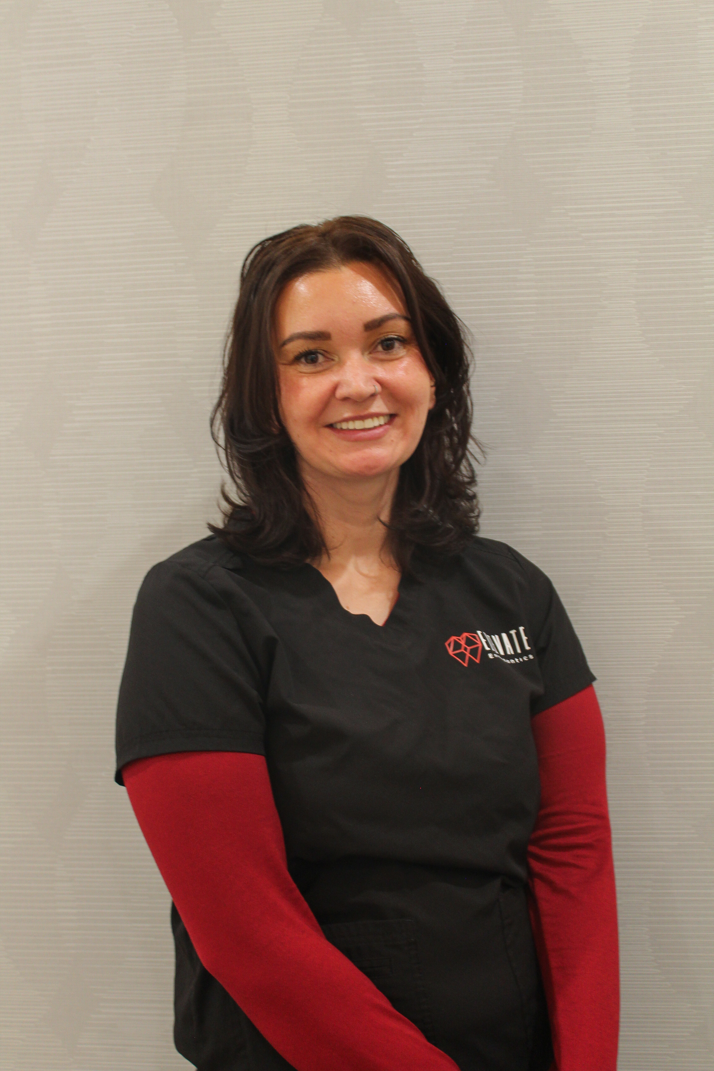 Brandy the office manager at Elevate Endo with Black scrubs