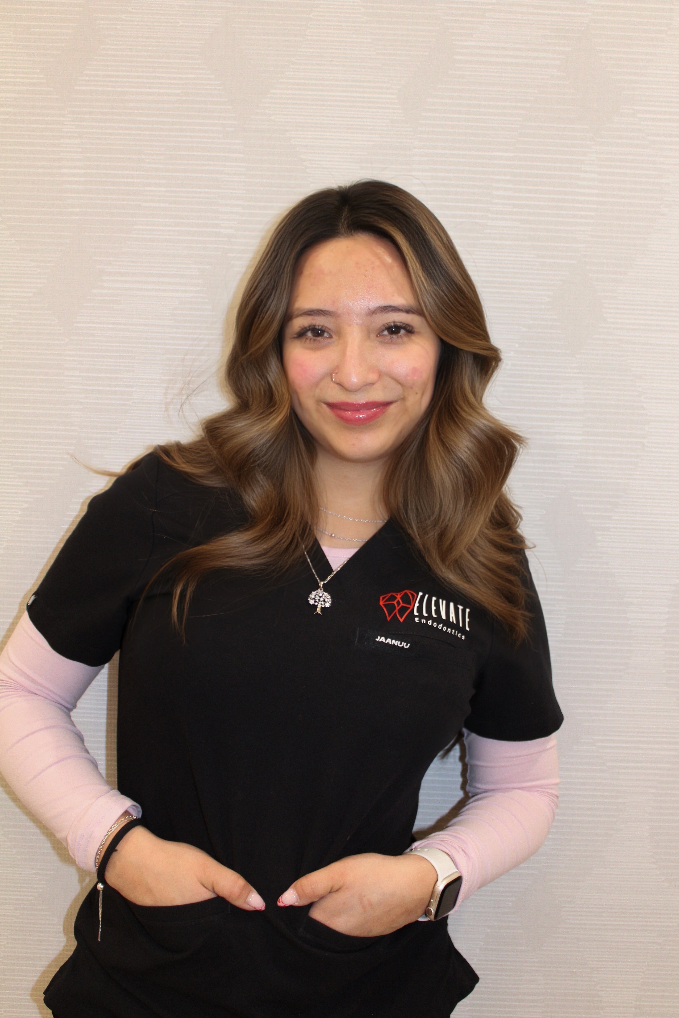 Ingy Elevate Endodontics dental assistant in black scrubs smiling